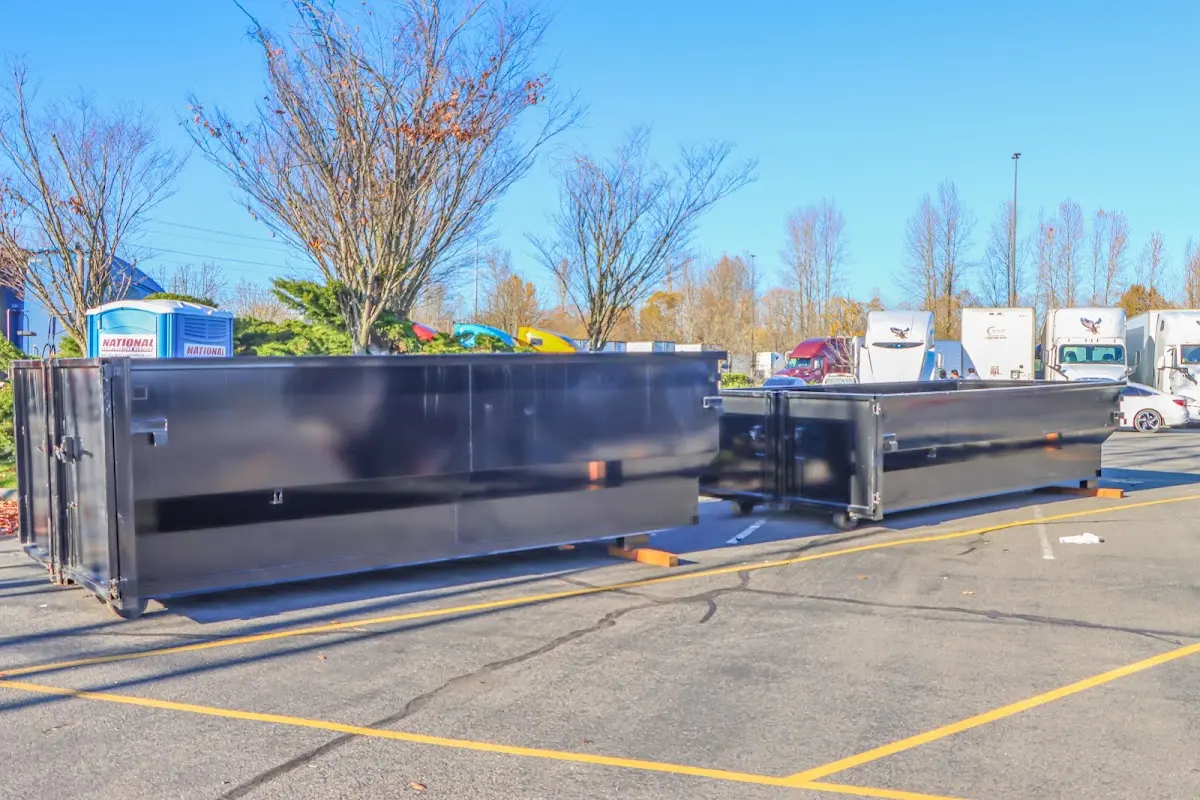 Professional dumpster rental service with roll-off container on residential driveway in Doolittle